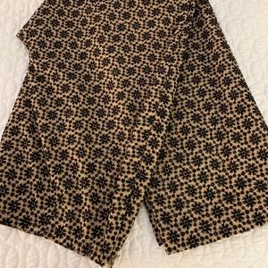 Creme pants with black embroidery.